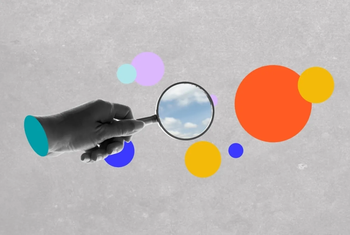 Digital collage of a hand with a magnifying glass | Skylum Blog