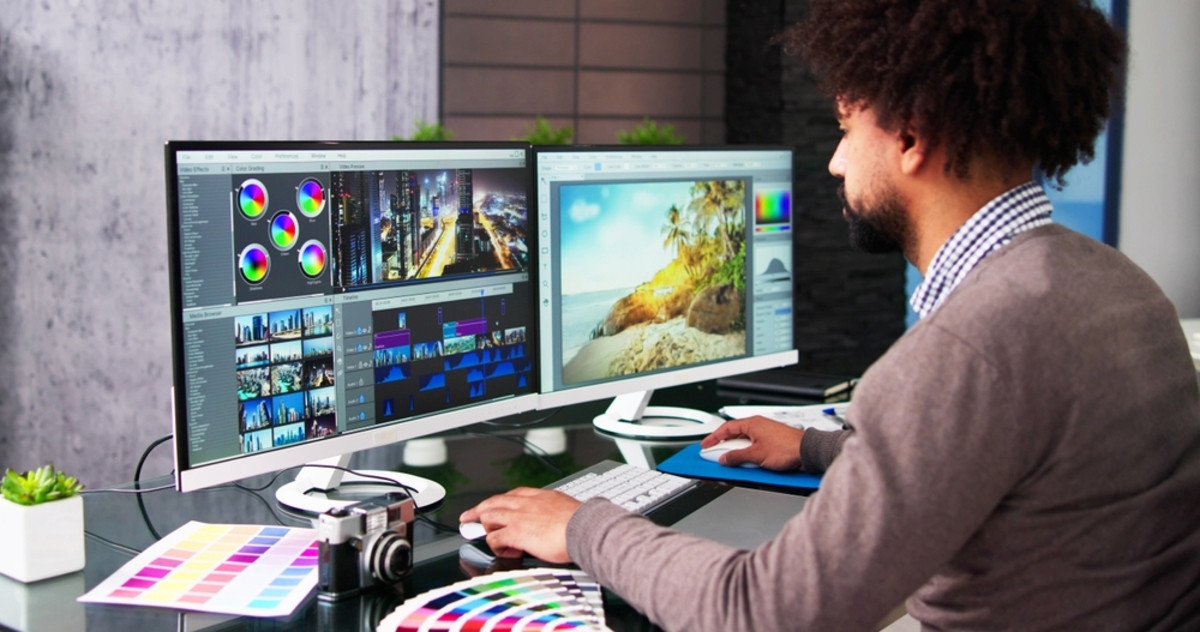 A photographer edits photos on two monitors | Skylum Blog
