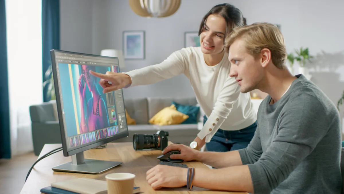 Photographers look at photos on a computer screen | Skylum Blog