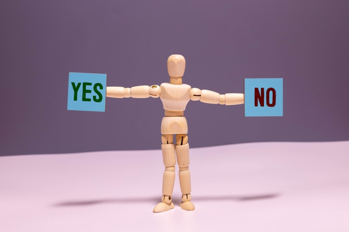 Wooden man with yes and no cubes | Skylum Blog