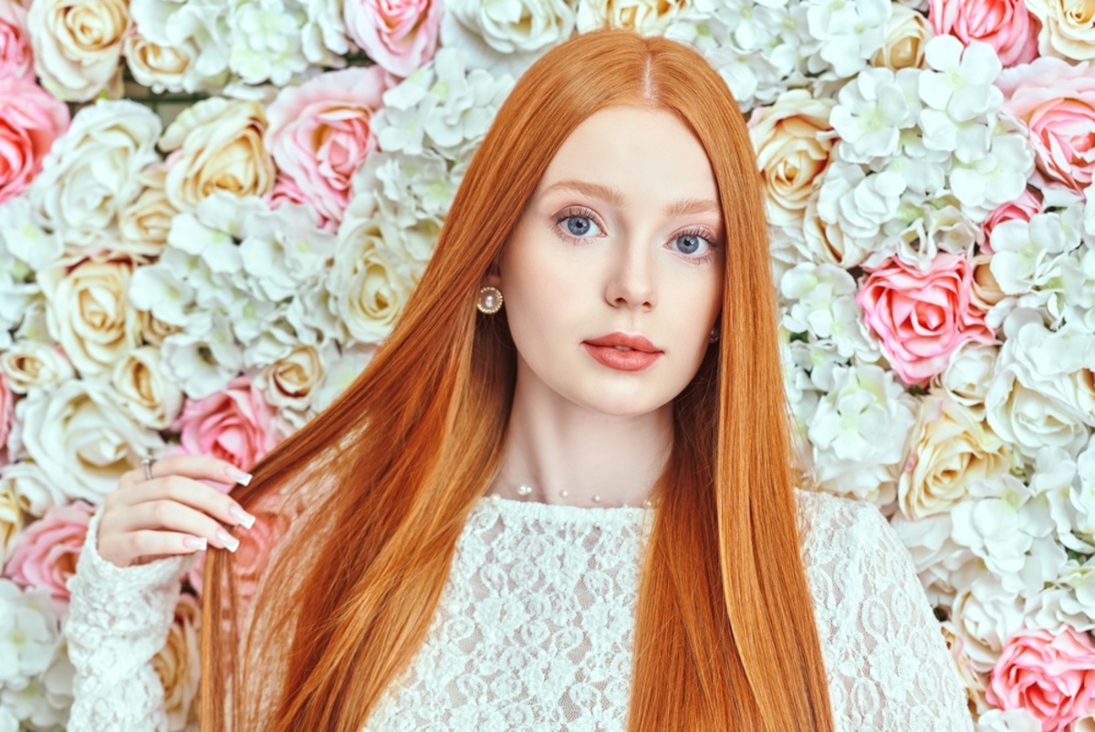 Portrait of a red-haired girl against a background of flowers | Skylum Blog

