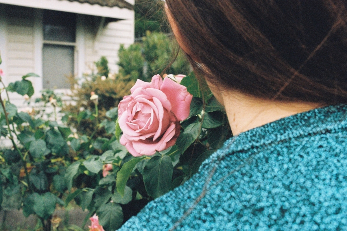 A photo of a girl from behind with a rose with a film effect | Skylum How-to

