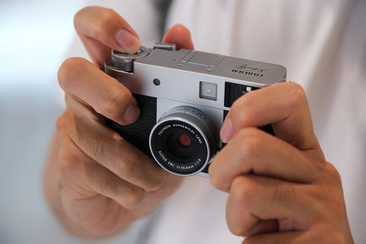 Fujifilm X100VI in the hands of a man | Skylum Blog