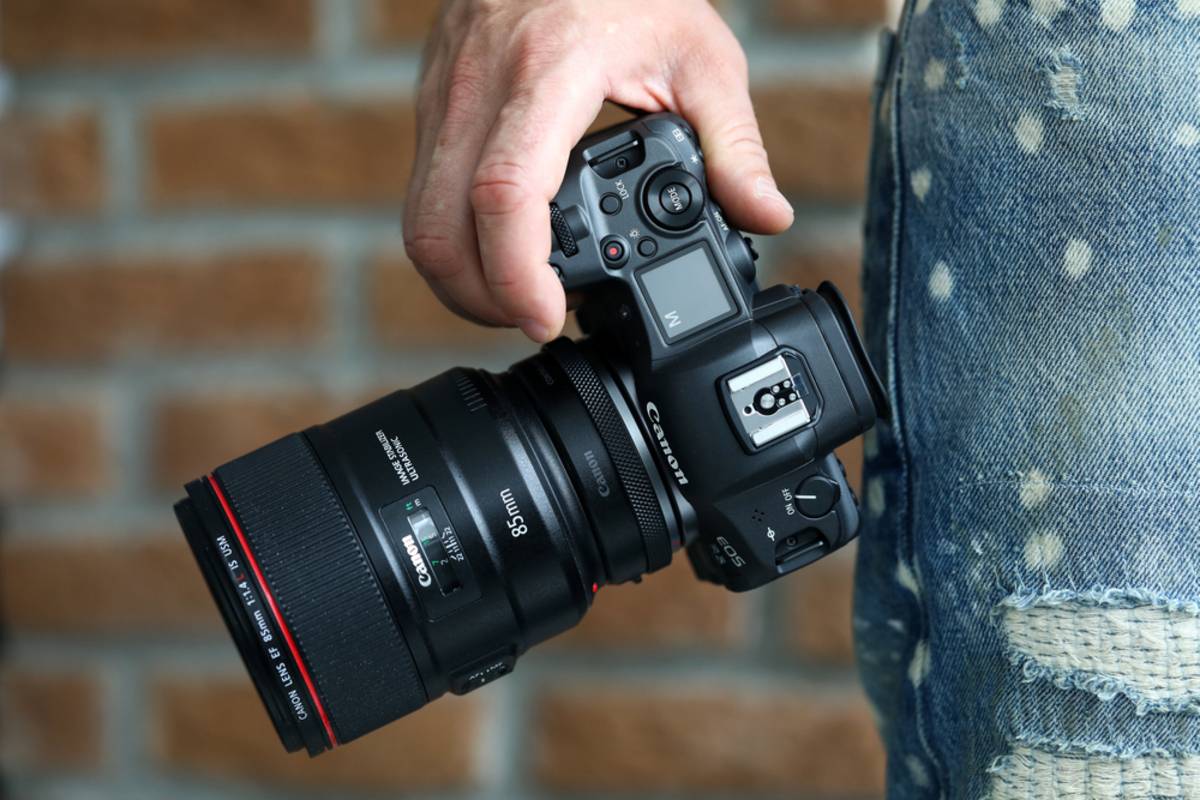 A photographer holds a Canon EOS R5 Mark II | Skylum Blog

