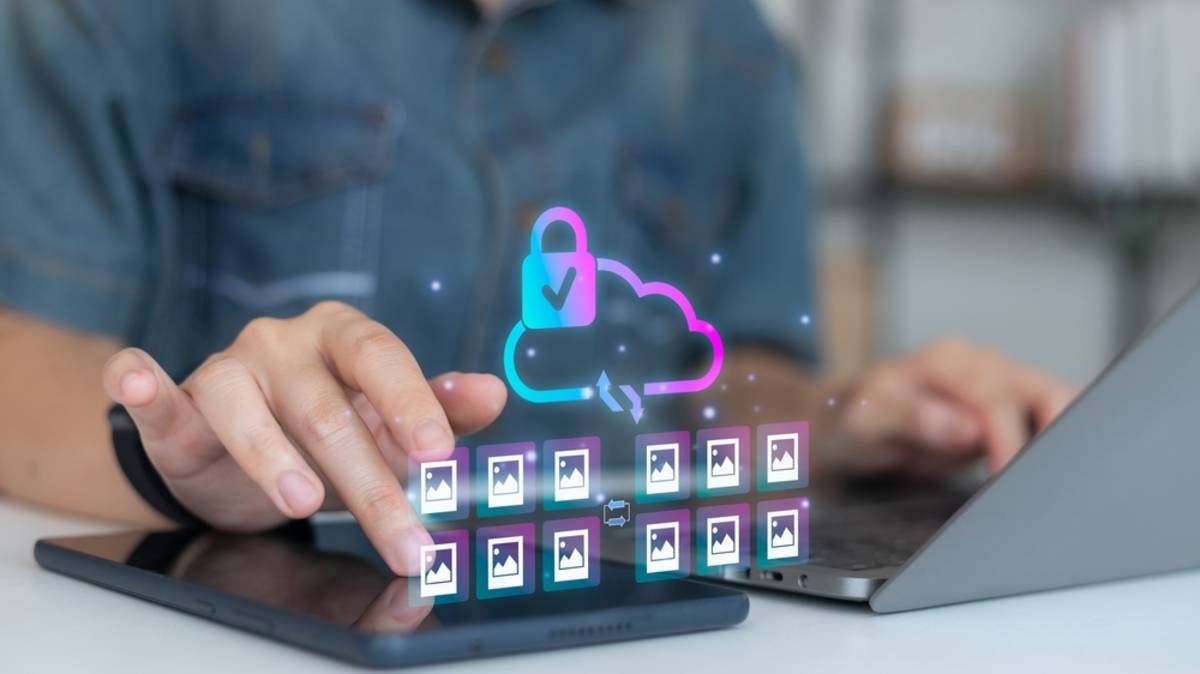 Person sharing photos from a laptop with cloud icons | Skylum How-to