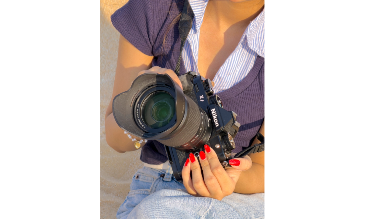 A girl holding a Nikon ZF | Skylum Blog