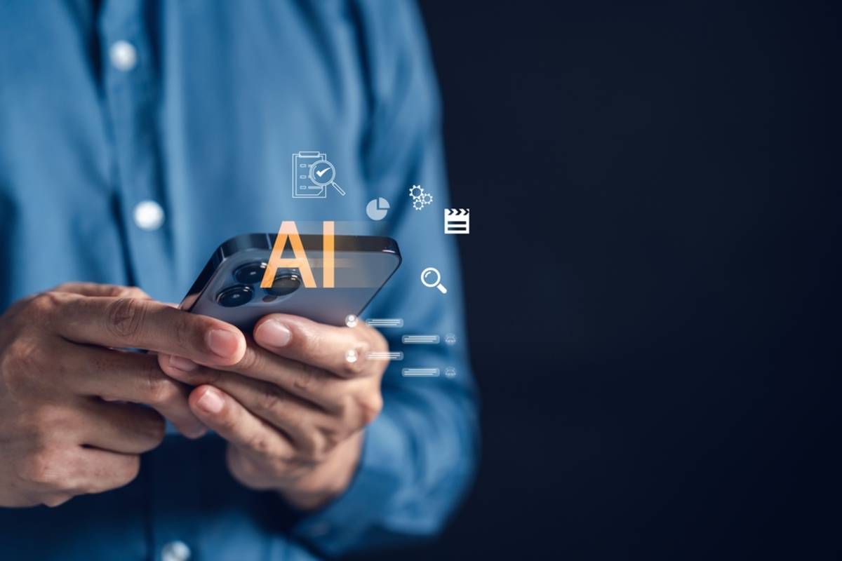 A man holds an iPhone with an AI icon | Skylum Blog

