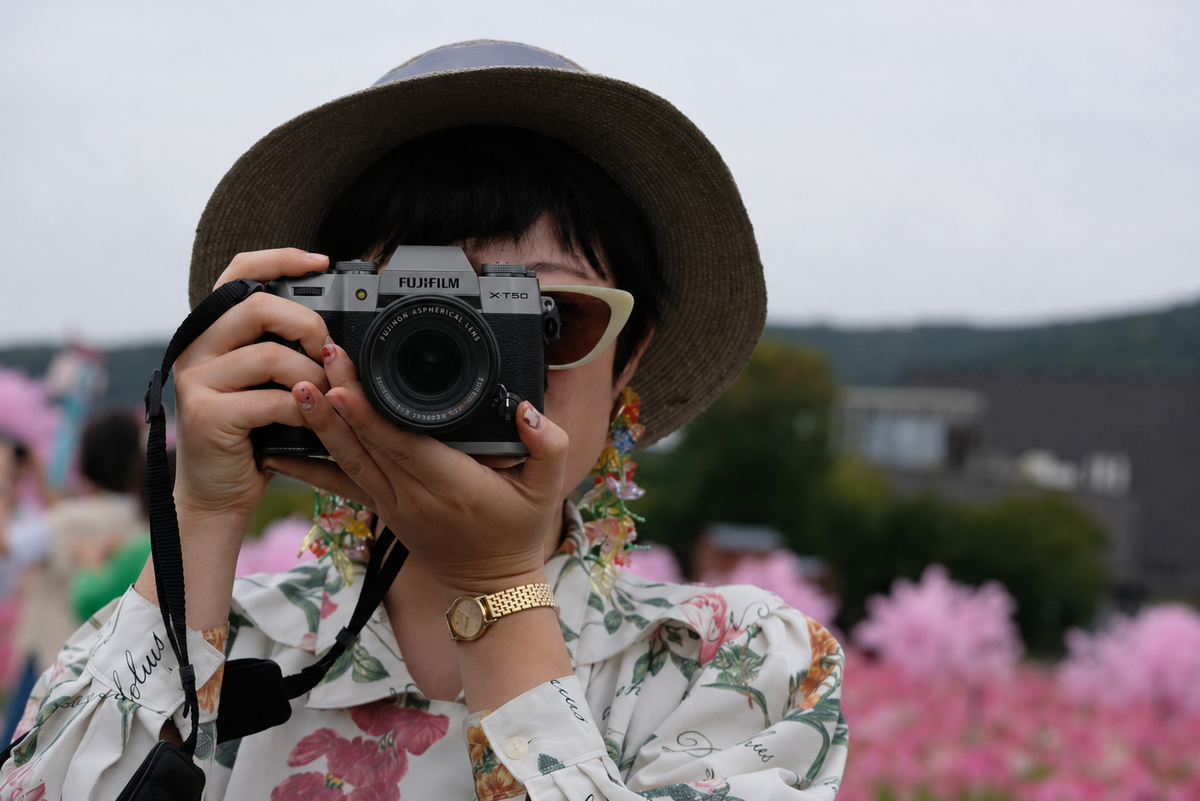 Photographer shooting with the Fujifilm X-T50 | Skylum Blog