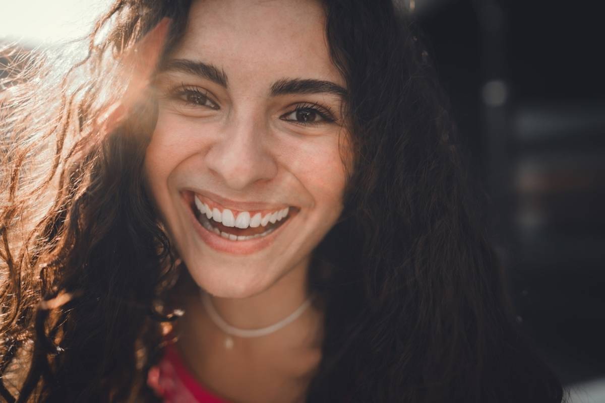 Close-up portrait of a laughing girl | Skylum Blog


