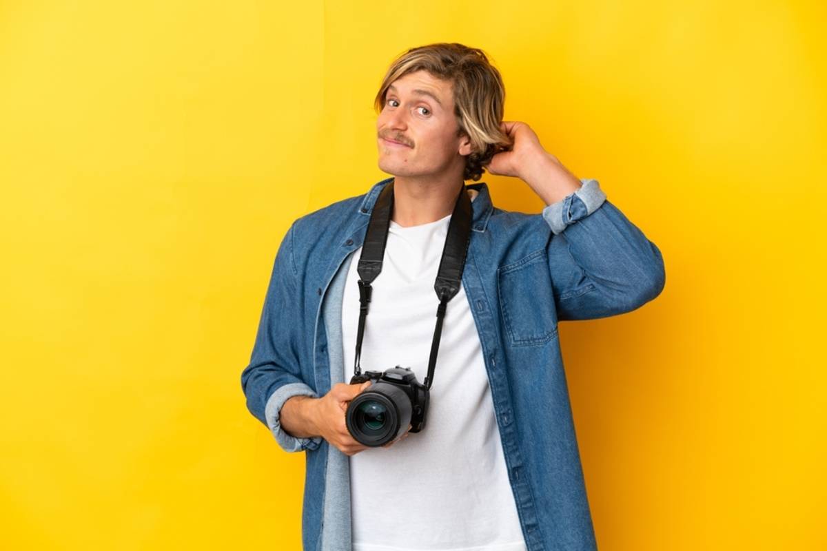 Photographer standing outdoors against a yellow background | Skylum Blog

