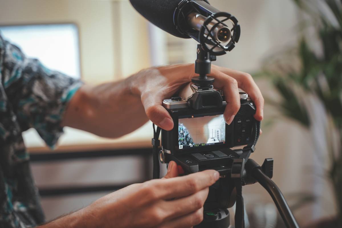 A photographer attaches a camera to a tripod | Skylum Blog

