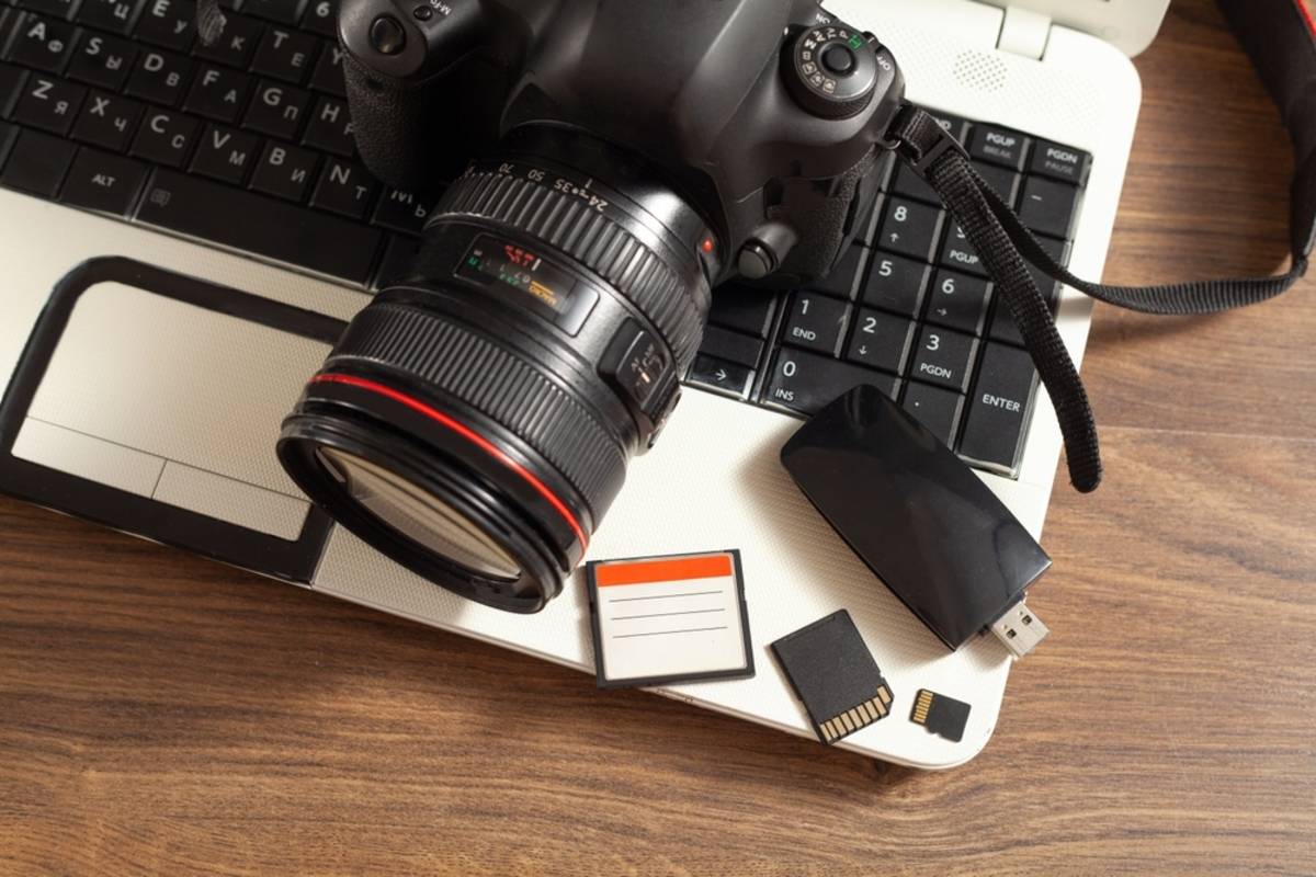 Camera with memory cards on a laptop | Skylum Blog

