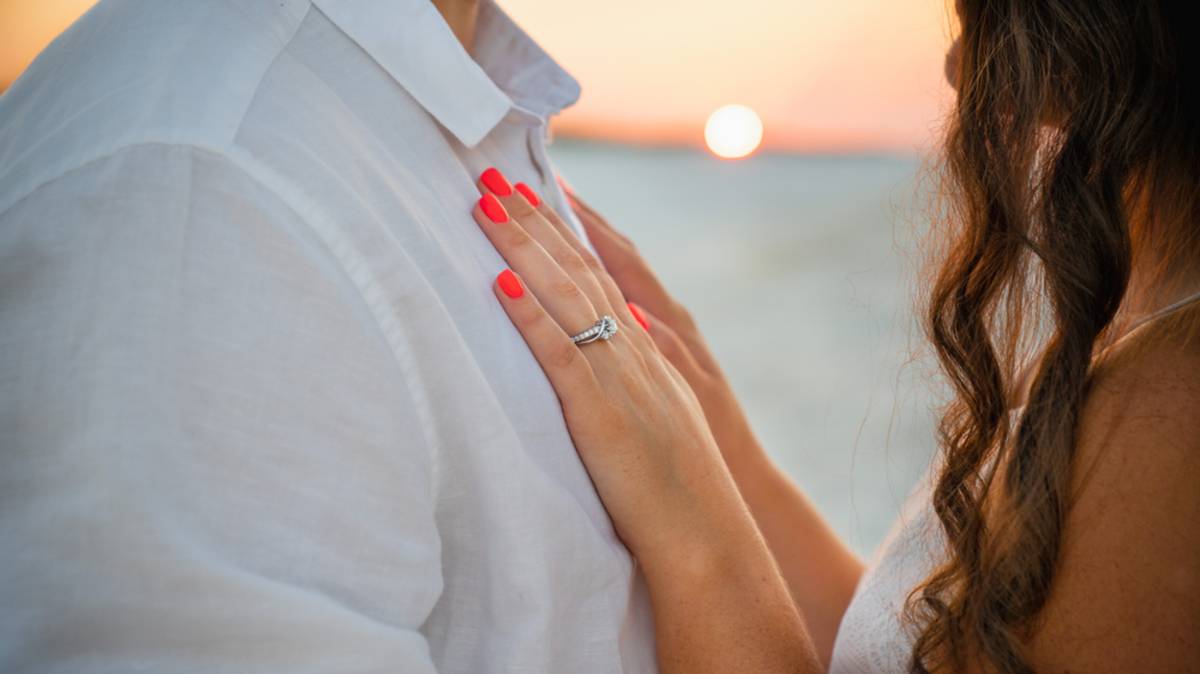 A close-up of a girl's hands with a ring on a guy's chest | Skylum Blog

