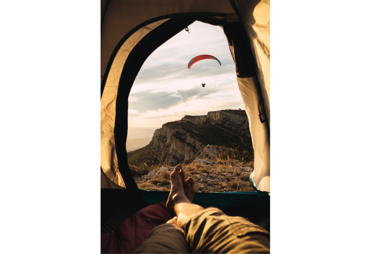 View through a tent at a distant landscape | Skylum Blog


