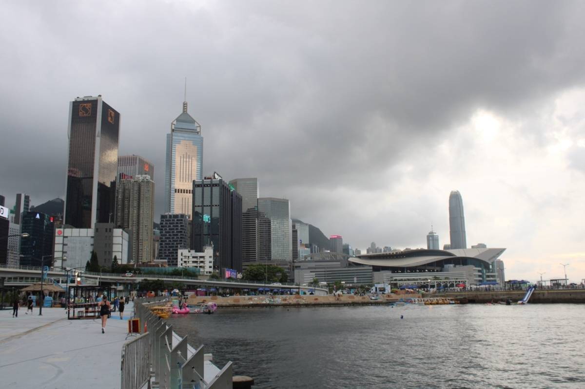 City skyline under dark cloudy skies | Skylum Blog


