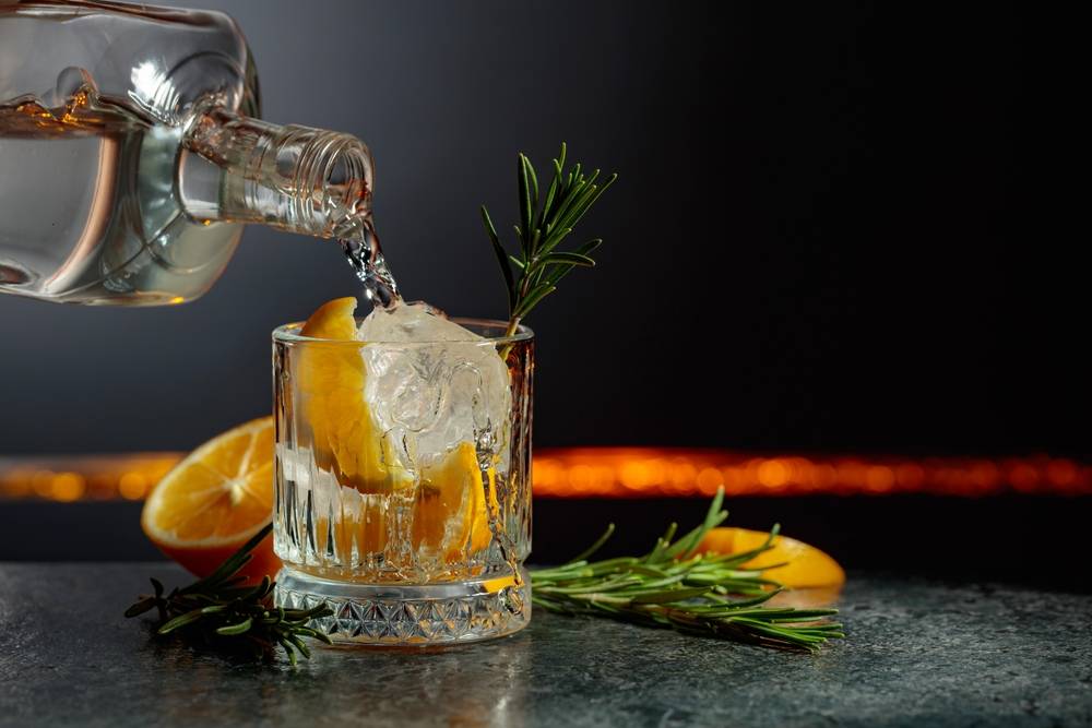 Liquid pouring into a cocktail glass with orange | Skylum Blog

