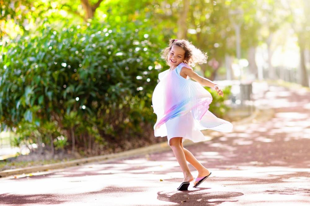 Happy kid playing in summer park