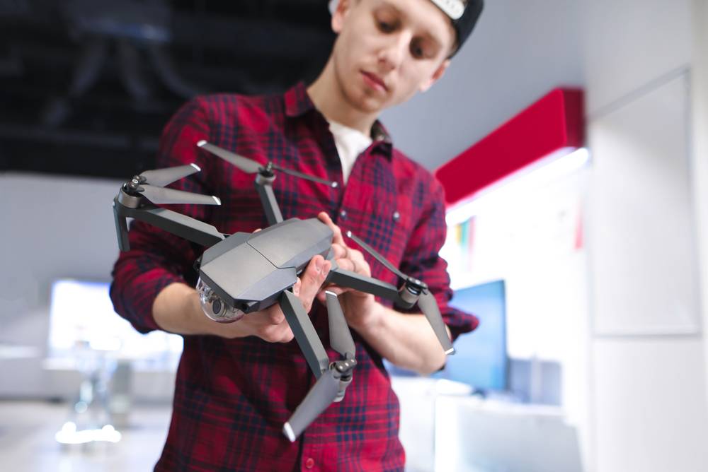 Person inspecting a drone before buying