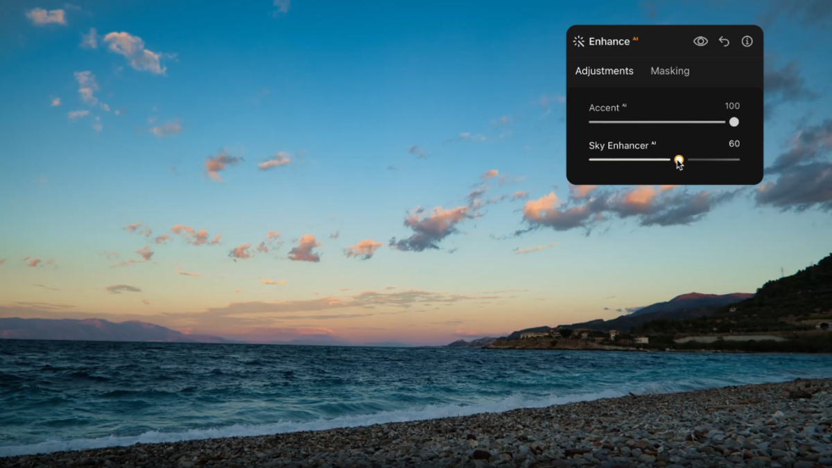 Luminar Enhance AI panel with Accent and Sky Enhancer sliders over a coastal sunset