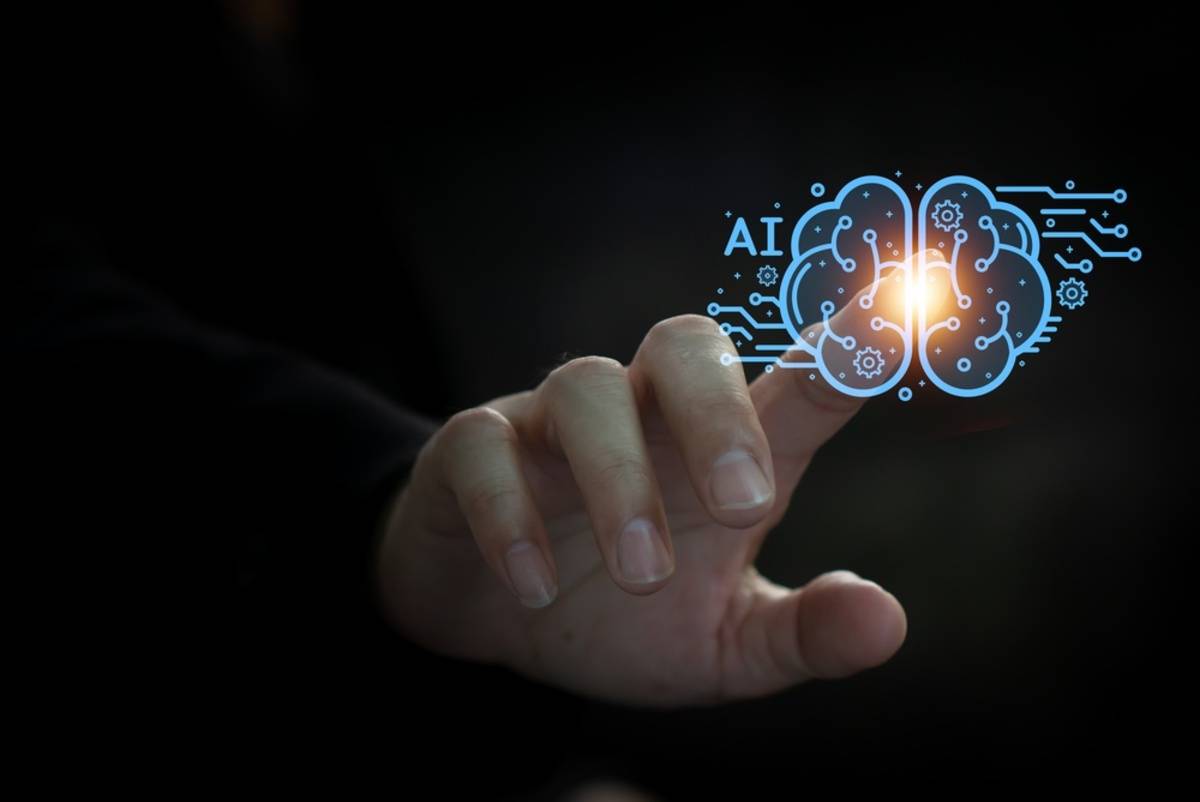 Finger touching a glowing AI brain icon with circuit lines against a dark background