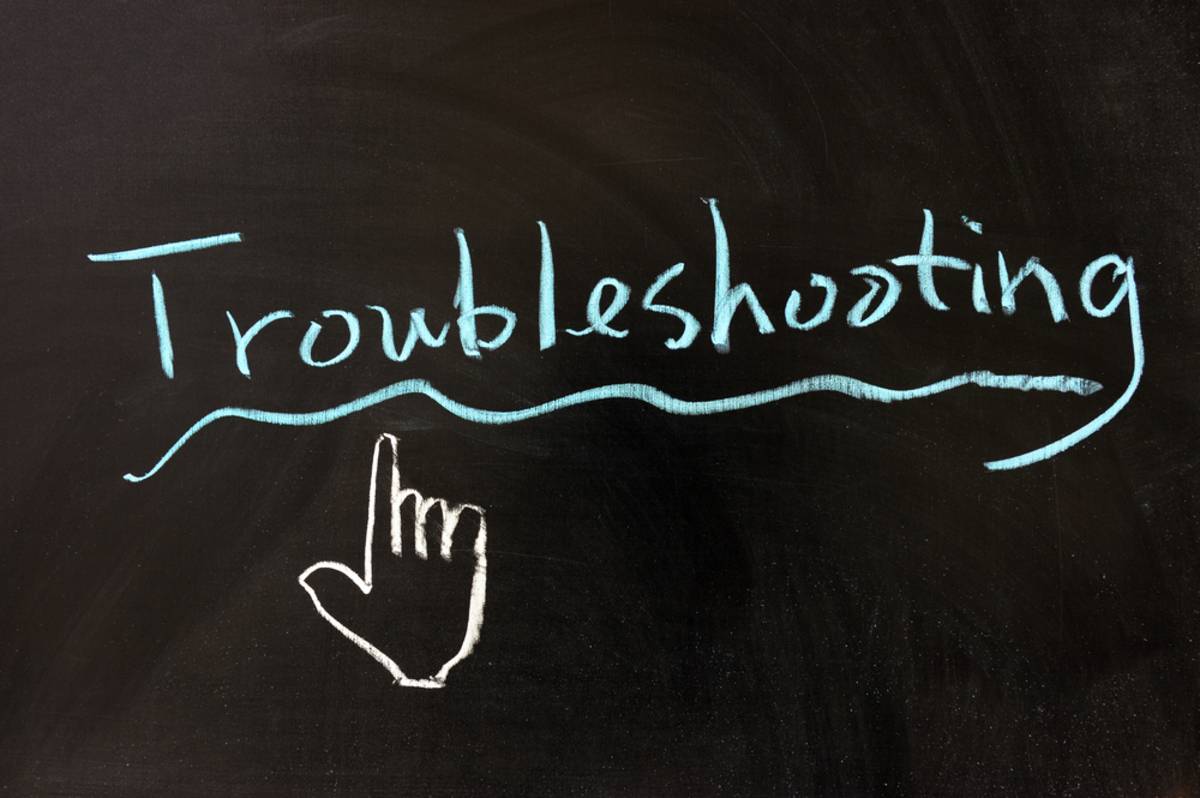 Chalkboard drawing of a pointing hand under the word Troubleshooting, underlined in blue